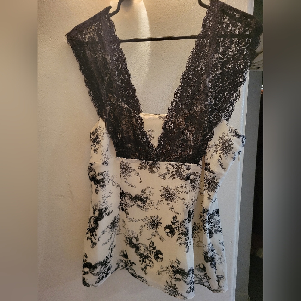 Beautiful cream cami shirt with black lace detail and black rose pattern